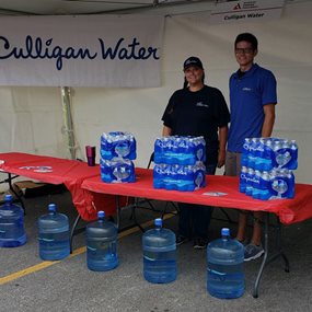 Staff at Culligan of North West Arkansas provide water at the Bentonville Tour de Cure