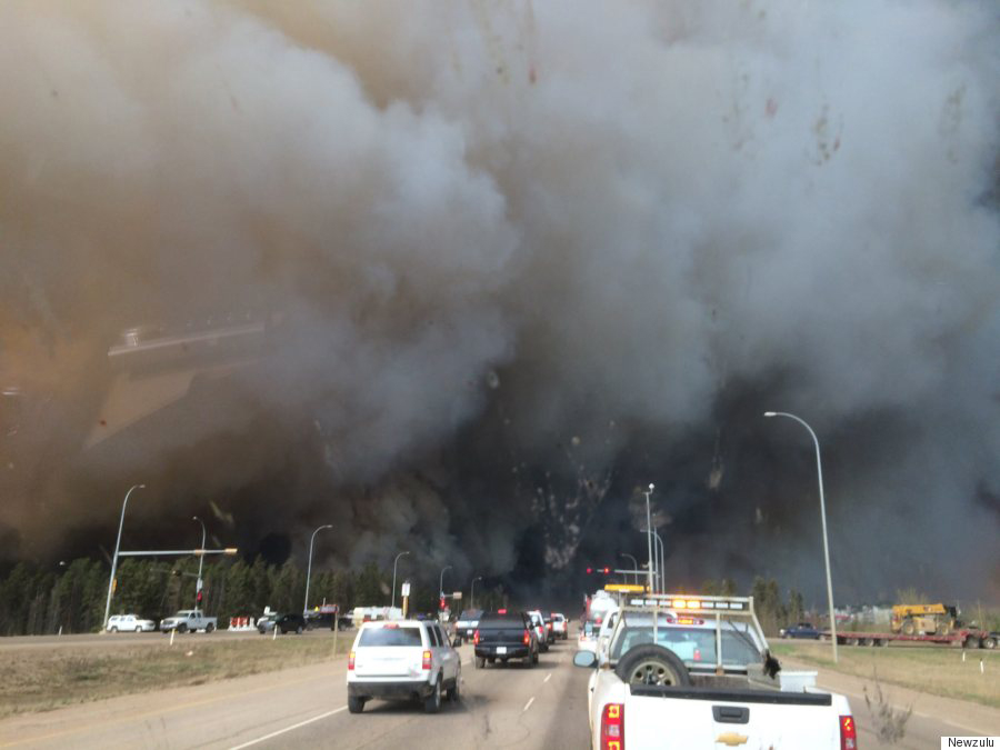 CANADA, Fort McMurray: Heavy smoke rises above Alberta Highway 63, near Fort McMurray, Alberta, southern Canada, as a huge wildfire has forced the evacuation of the entire population of the Canadian city, on May 3, 2016. The evacuation from Fort McMurray is the biggest in Alberta's history.